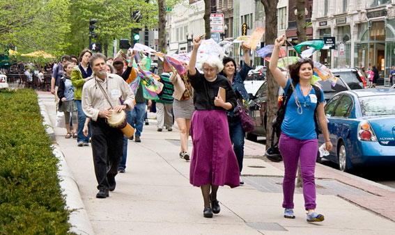 Participants in "Words Are Not Enough" carry prayer flags to the Boston Marathon bombing memorial site in Copley Square.