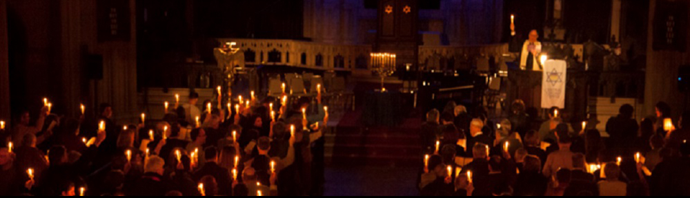Wide angle view of congregation holding up candles
